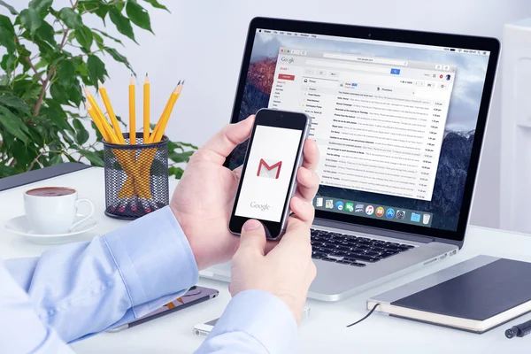 a person using mobile phone to access gmail